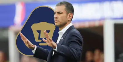 Jaime Lozano junto al escudo de Pumas / FOTO EFE